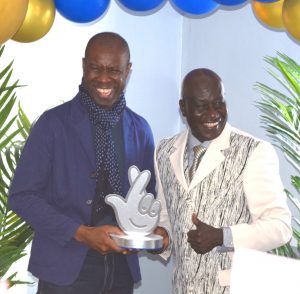 BBC presenter Clive Myrie presents Maxwell with a Community Champion 2021 Award